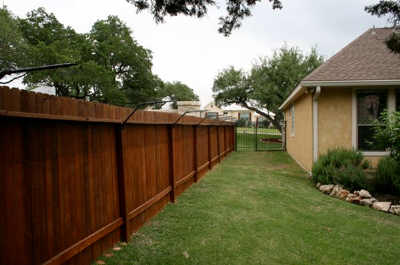 Purr...fect Cat Fence added to top of existing wooden fence Fenced yard showing cat fencing added to top of existing wooden fence