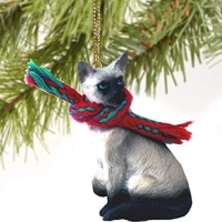 Seal point Siamese cat tree ornament made of resin, with removable winter scarf and gold cord.