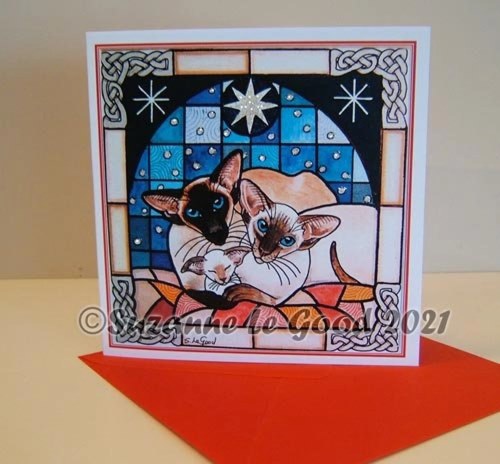 Seal and Chocolate Point Siamese cats and kitten against a snowy, starry stained glass window. Christmas nativity card by Suzanne Le Good