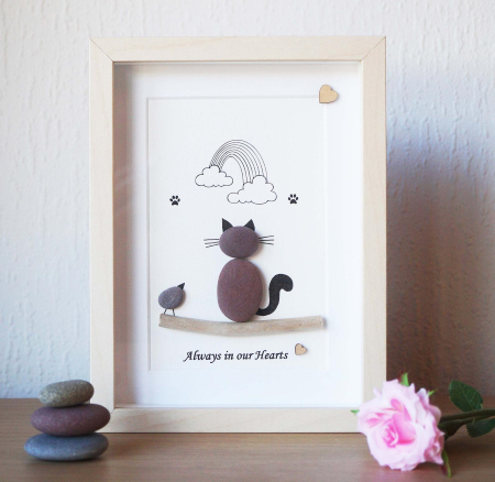 Pebble art memorial picture depicting Siamese cat looking at a rainbow