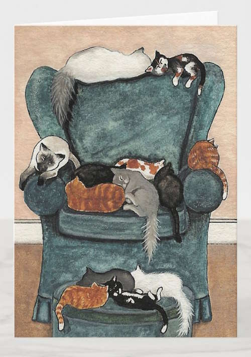 Thirteen cats of all colors and sizes snuggle and snooze on the back, arms and seats of a plush green armchair and footstool.