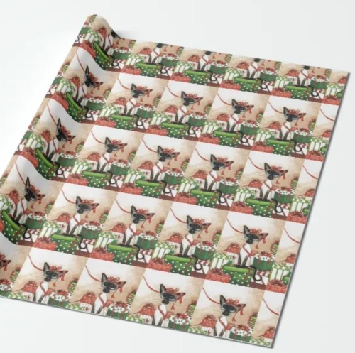 Christmas wrapping paper in red and green design of Siamese cat playing with Christmas ribbon and gifts