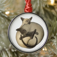 Two sleeping Siamese cats on a white background, circular tree decoration with red hanging ribbon